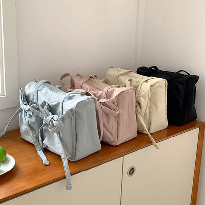 Nylonowa torebka na ramię z kokardkami